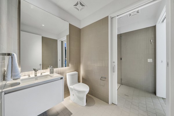 Bathroom featuring modern fixtures and sleek design in Kurve Apartments