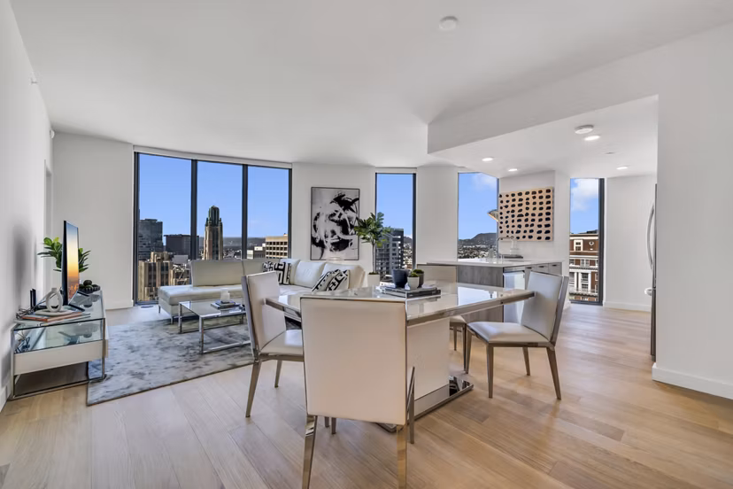 Dining area with stylish seating and modern lighting at Kurve Apartments