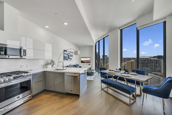 Modern kitchen with stainless steel appliances and quartz countertops at Kurve Apartments