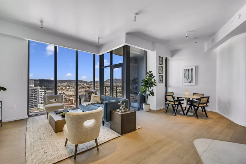 Bright living room with modern decor and ample seating at Kurve Apartments