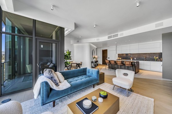 Elegant living room featuring modern decor and natural light at Kurve Apartments