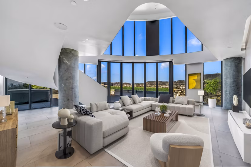 Spacious living room with modern decor and large windows at Kurve Apartments