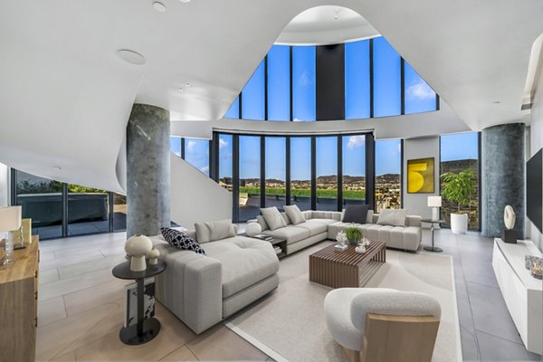 Spacious living room with modern decor and large windows at Kurve Apartments