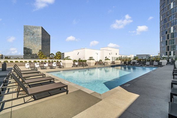 Resort-style pool with lounge chairs at Kurve Apartments in the luxury Greystar community