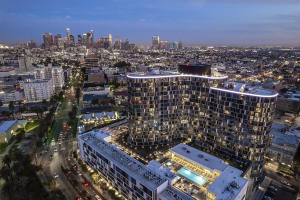 Skyline view at Kurve Apartments: Luxury cityscape vistas from a high-rise balcony
