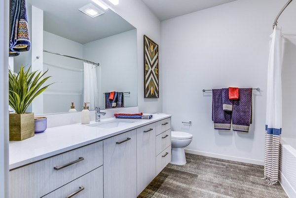Modern bathroom featuring sleek fixtures and elegant tiling at Batik Apartments