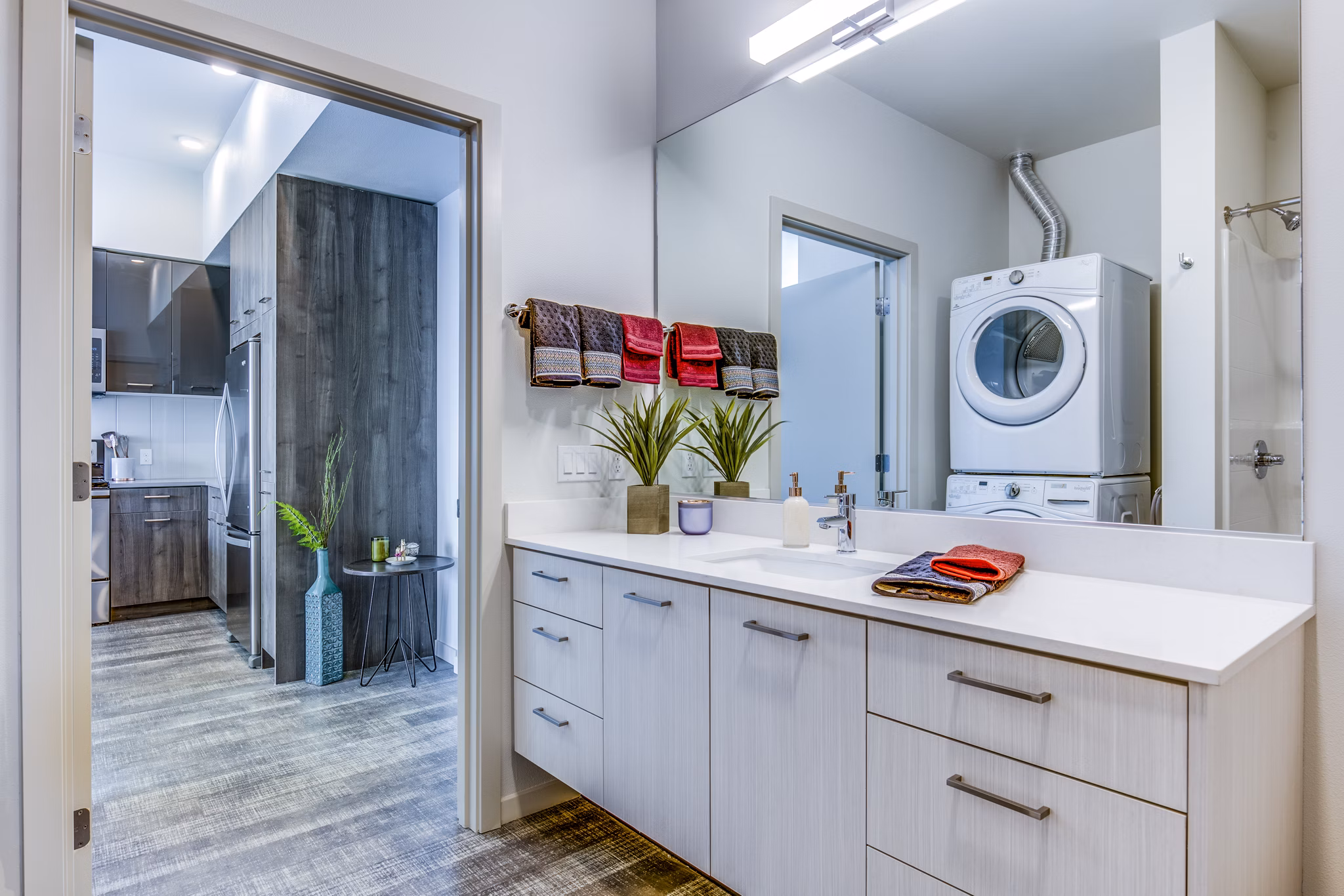 Modern bathroom featuring elegant fixtures and large vanity at Batik Apartments