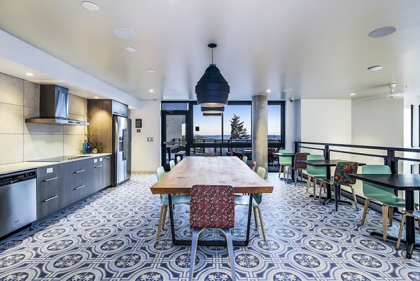 Clubhouse kitchen featuring modern appliances and spacious layout at Batik Apartments