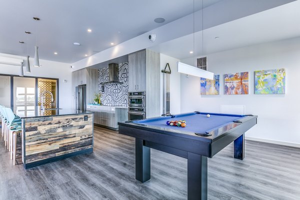 Clubhouse patio with modern game room at Batik Apartments, featuring recreational spaces designed for luxury living