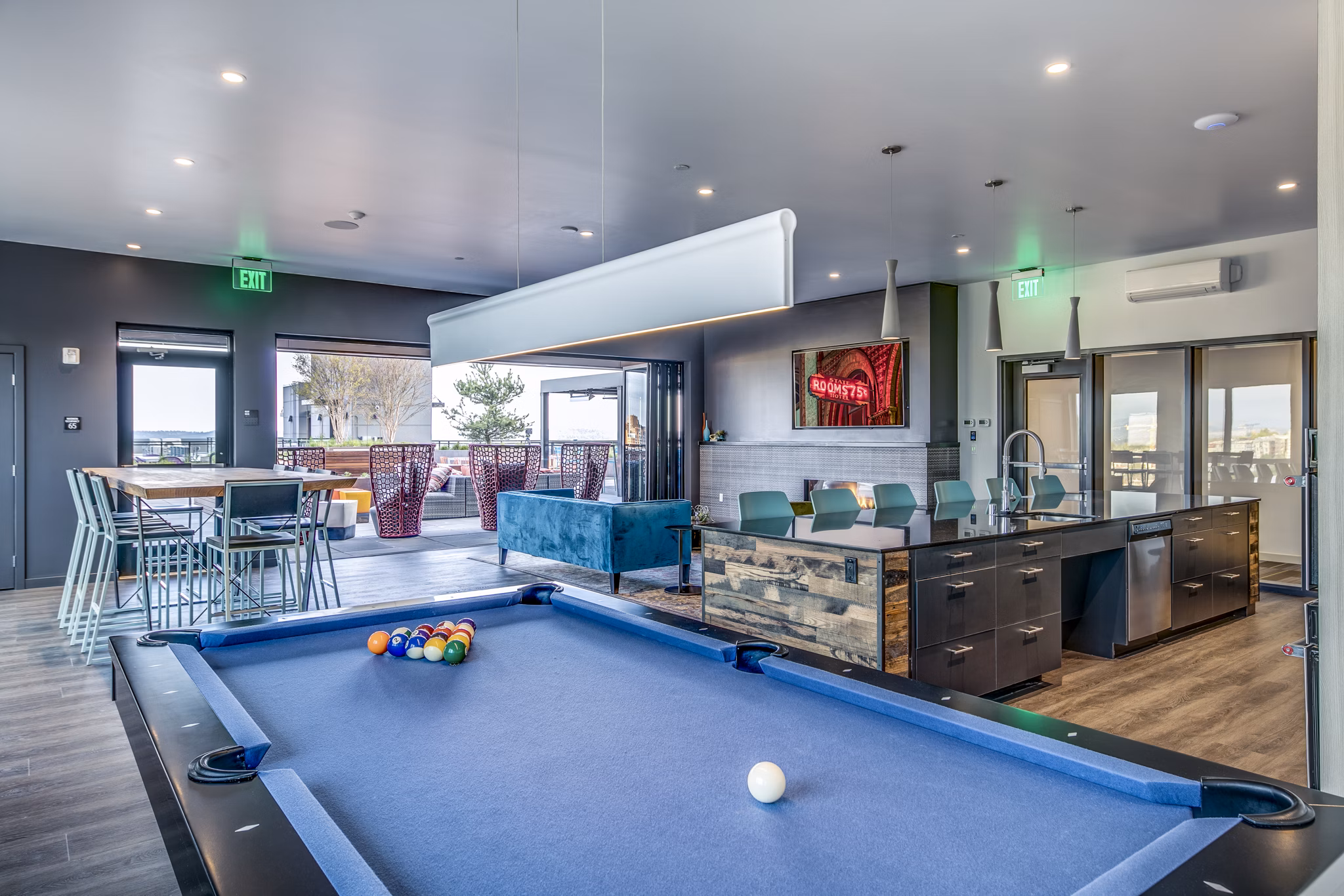 Outdoor patio and game room at Batik Apartments with modern seating and entertainment options for luxury living