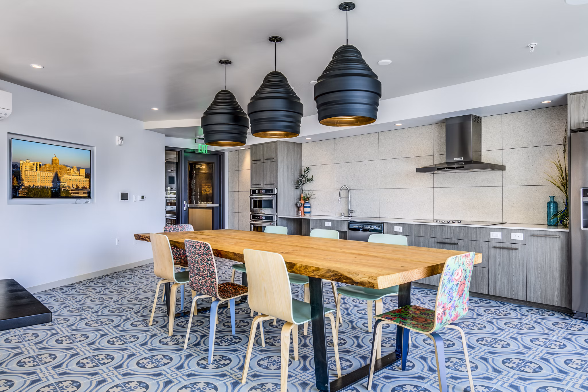Clubhouse kitchen featuring modern appliances and spacious island at Batik Apartments, a luxury Greystar property in an urban setting