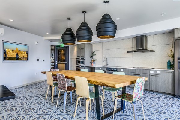 Clubhouse kitchen featuring modern appliances and spacious island at Batik Apartments, a luxury Greystar property in an urban setting