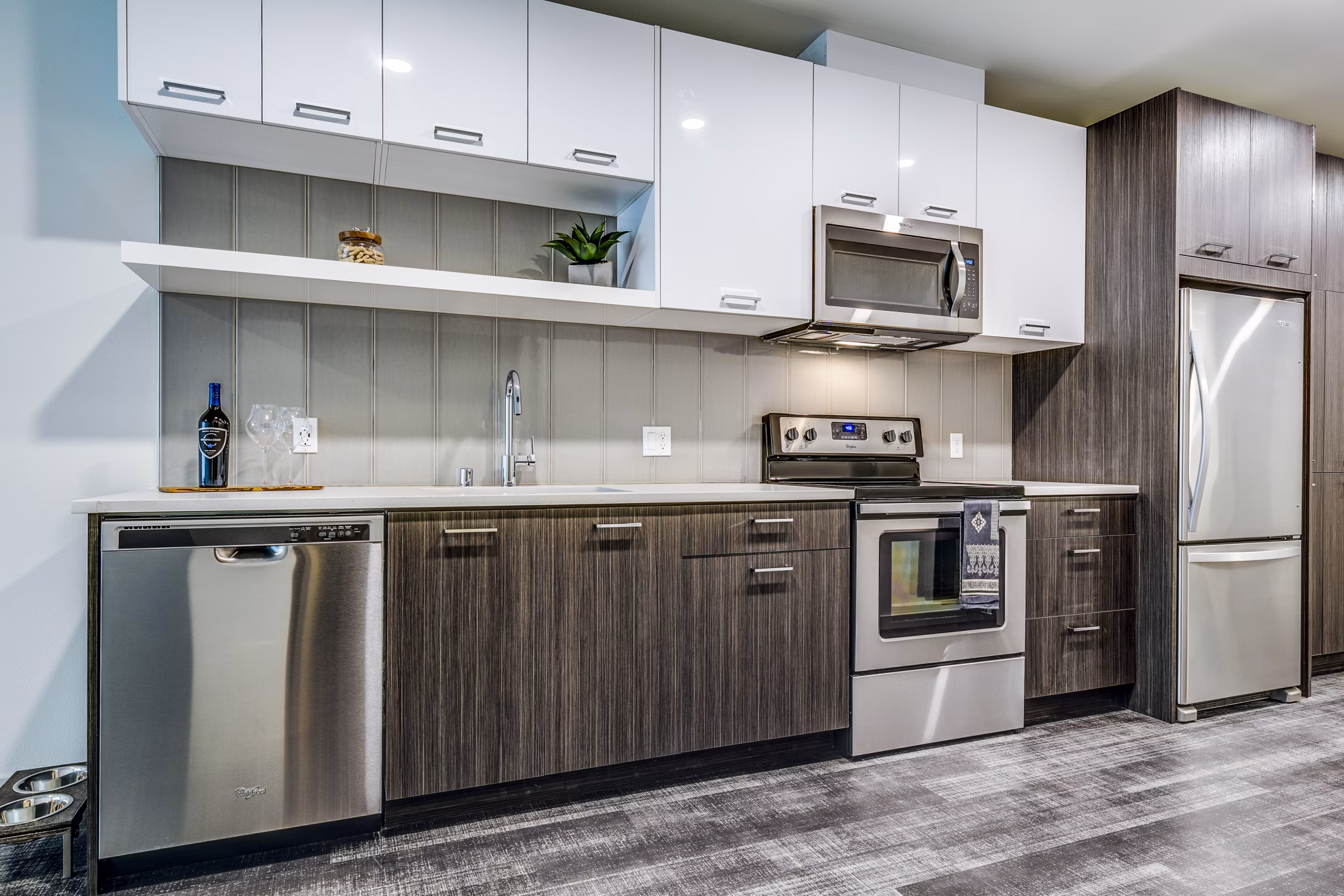 Modern kitchen with sleek countertops and stainless steel appliances in Batik Apartments