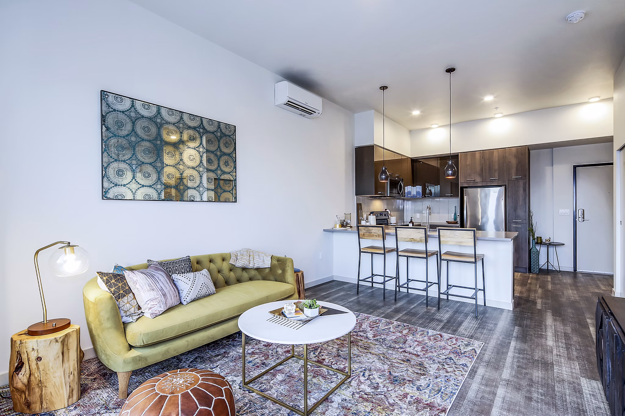 Spacious living room with modern decor and natural light at Batik Apartments