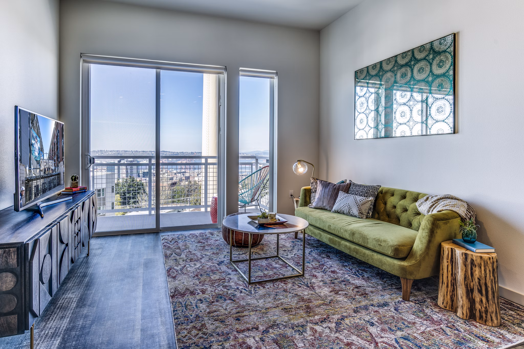 Spacious living room featuring modern decor and large windows in Batik Apartments