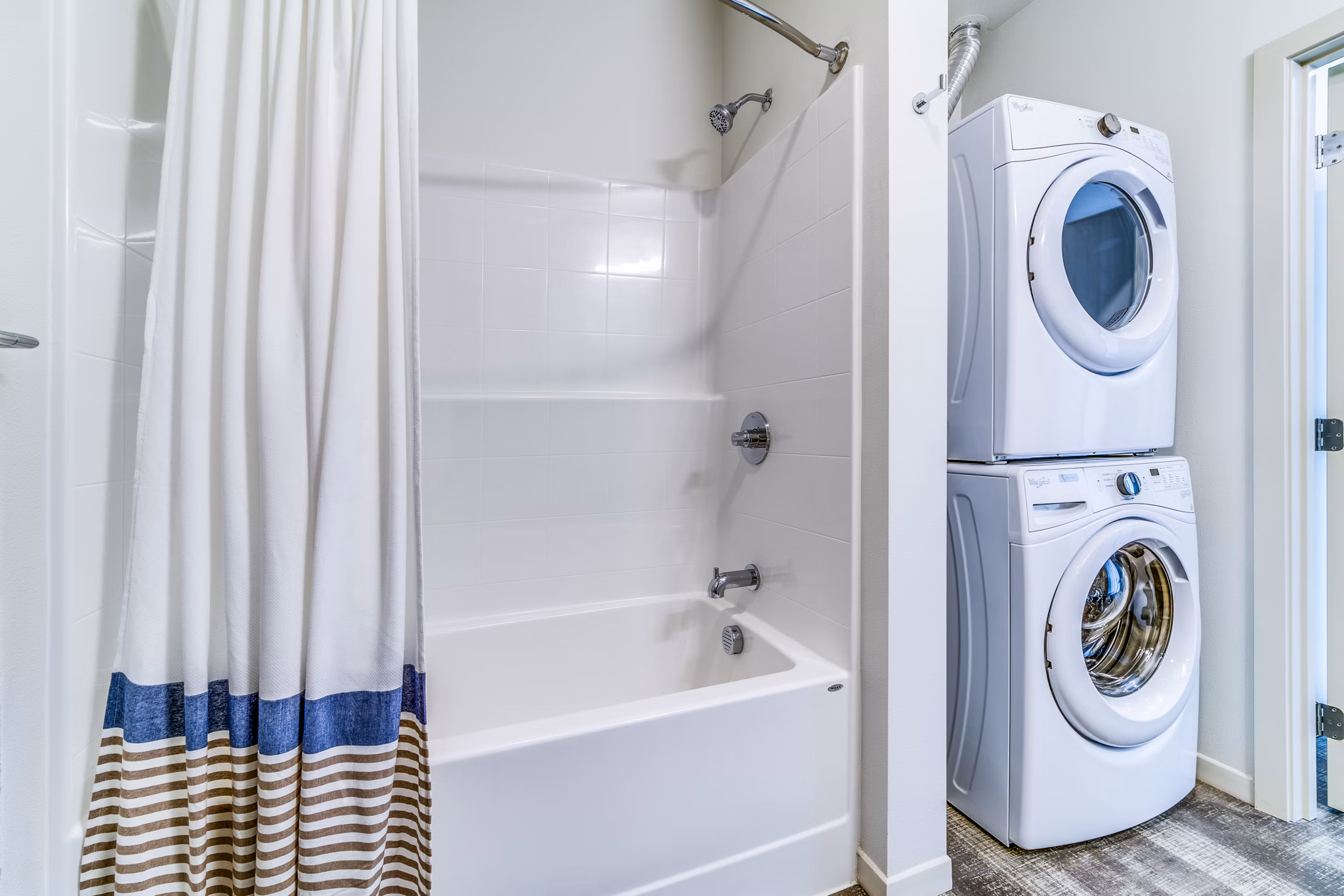 Boutique bath and laundry room with modern appliances in Batik Apartments