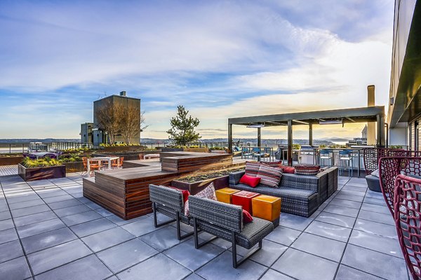 Batik Apartments: Modern patio with stylish seating and greenery