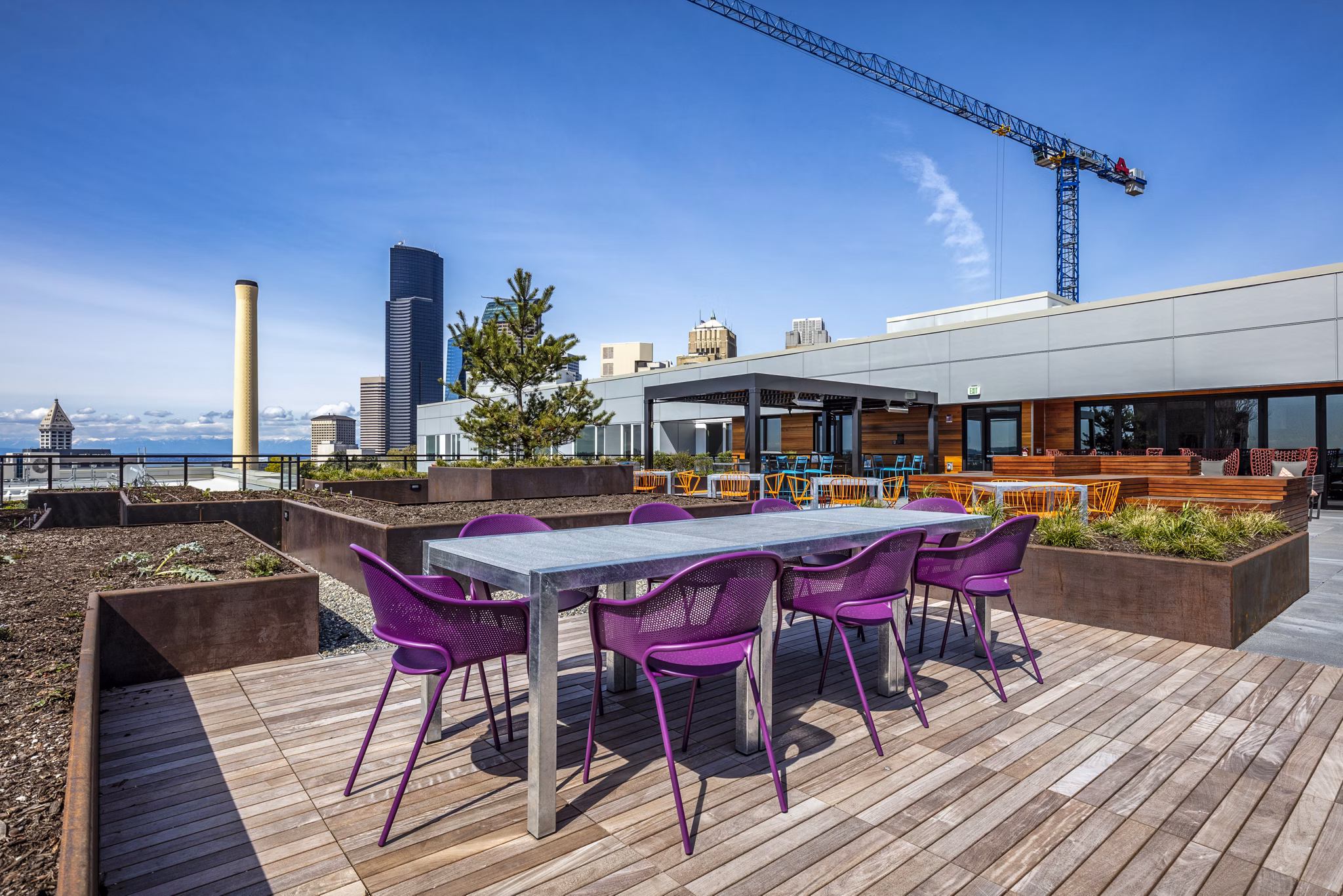 Patio with stylish seating at Batik Apartments, offering luxury outdoor living space with city views