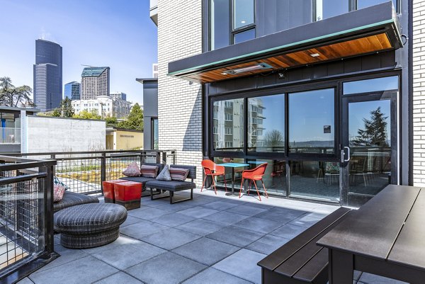 Clubhouse patio with modern outdoor seating at Batik Apartments, offering a cozy space for relaxation and social gatherings