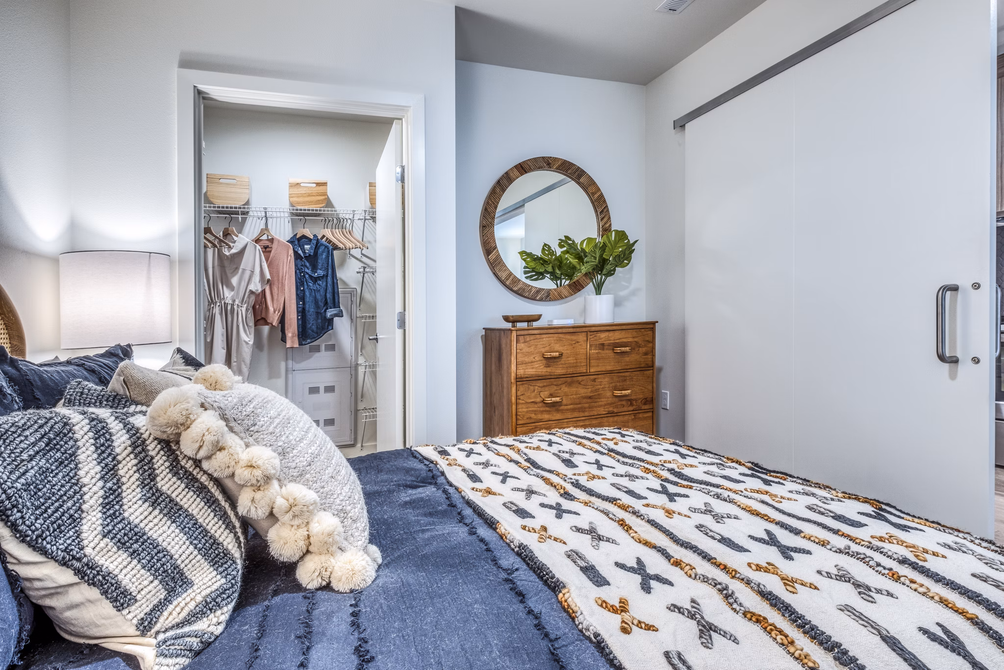 Bedroom with modern decor and large window in Cypress Apartments, a luxury property by Greystar