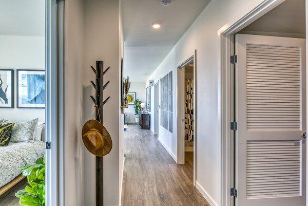 Hallway with elegant lighting and modern design at Cypress Apartments, showcasing luxury living spaces
