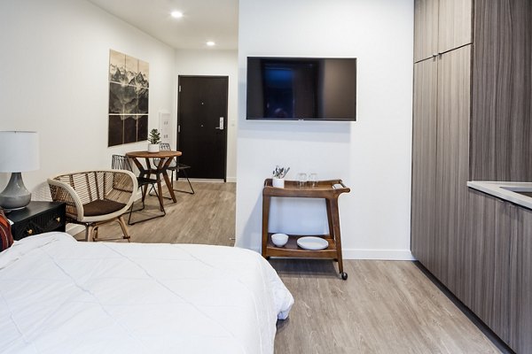 Studio bedroom with modern decor and natural light at Cypress Apartments