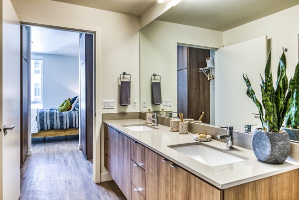 Spacious bathroom with sleek design at Cypress Apartments, featuring modern fixtures and ample storage options