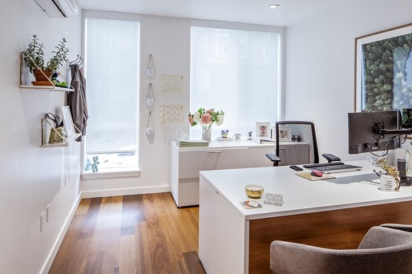 Modern leasing office with sleek design at Cypress Apartments, featuring comfortable seating and contemporary decor