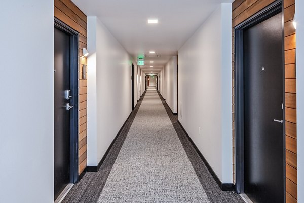 Wide hallway with modern lighting at Cypress Apartments, a Greystar luxury residence