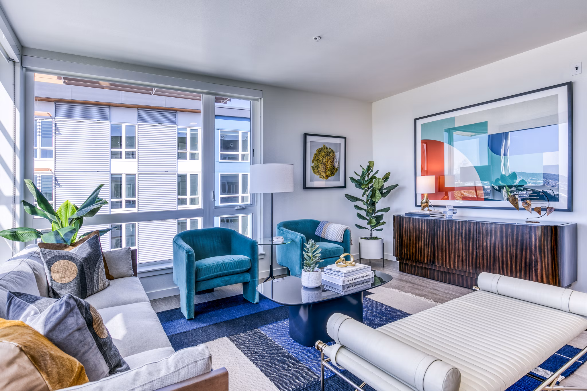 Cozy living room with modern decor and large windows in Cypress Apartments, ideal for relaxation and entertainment