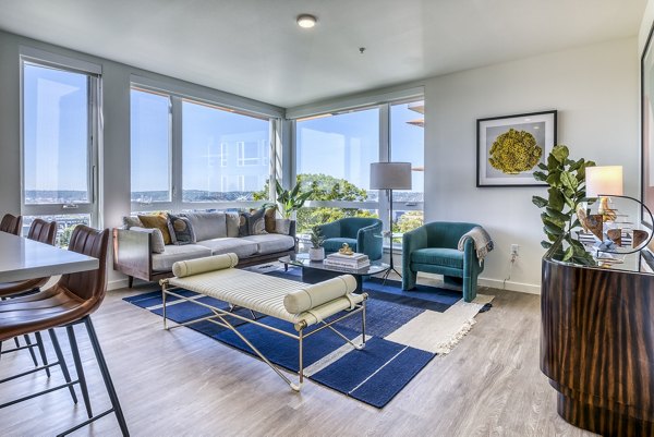 Spacious living room with modern decor and large windows in Cypress Apartments