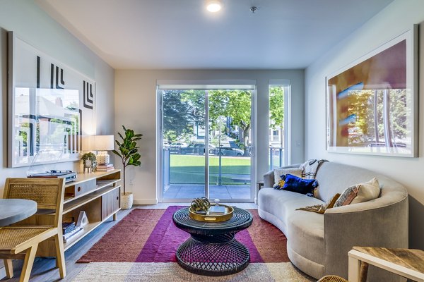 Spacious living room with modern furnishings in Cypress Apartments, a Greystar luxury community