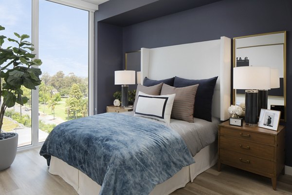 Spacious bedroom with modern decor at 525 Olive Apartments, offering luxury living in an upscale urban setting