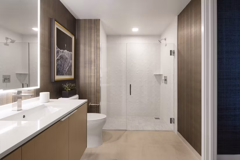 Bathroom featuring contemporary fixtures and marble countertops at 525 Olive Apartments