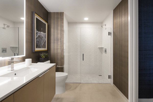 Bathroom featuring contemporary fixtures and marble countertops at 525 Olive Apartments