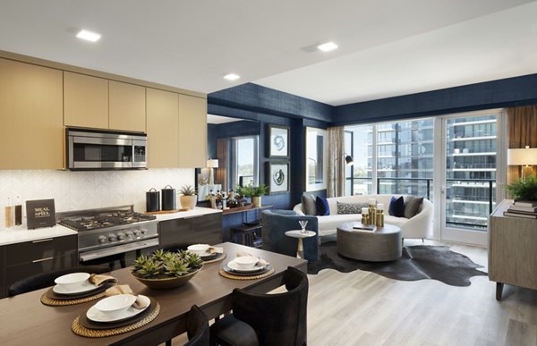 Dining area with sleek furnishings and natural light at 525 Olive Apartments Luxury