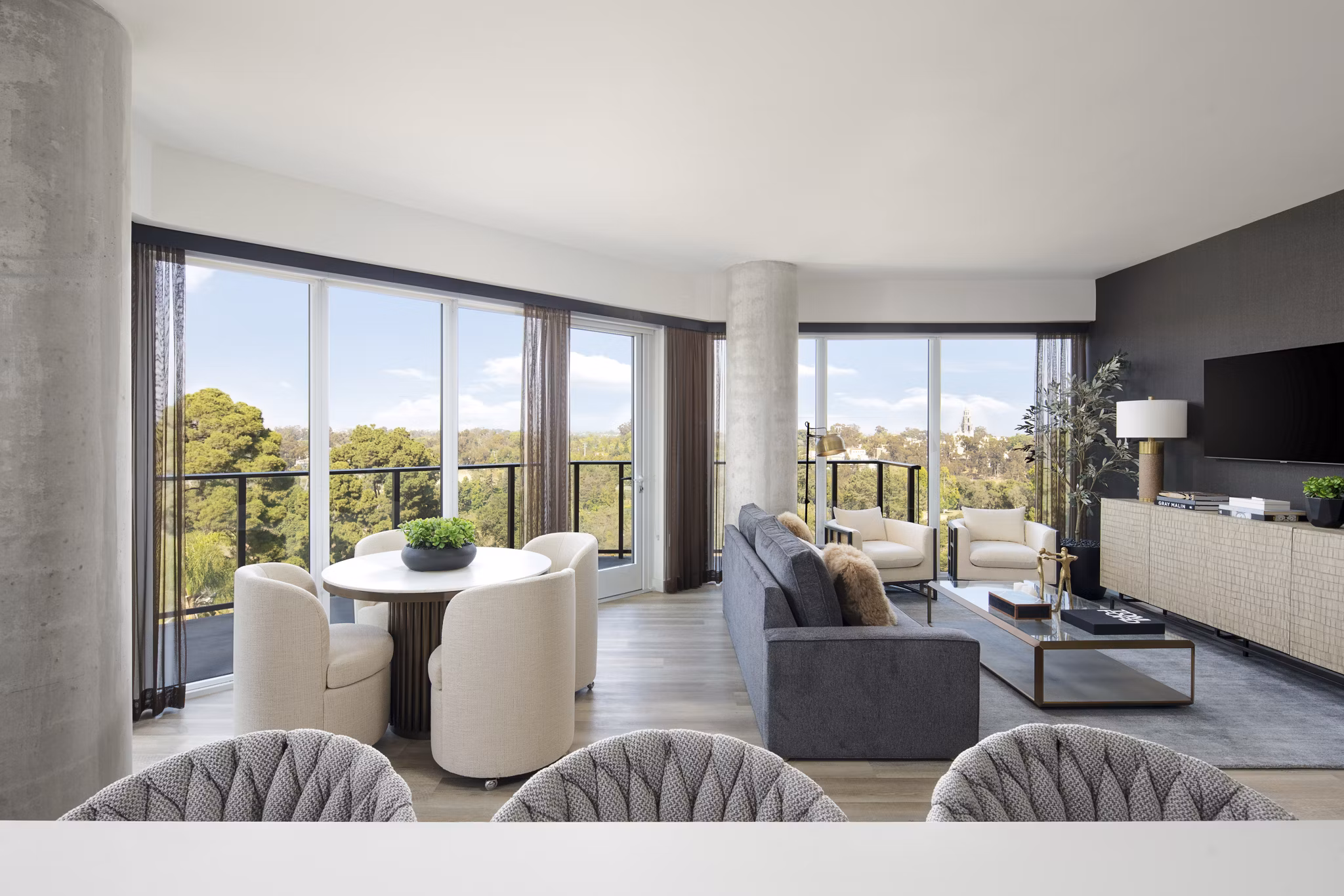 Modern kitchen with stainless steel appliances and quartz countertops in 525 Olive Apartments