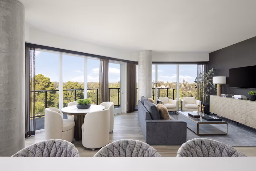 Modern kitchen with stainless steel appliances and quartz countertops in 525 Olive Apartments