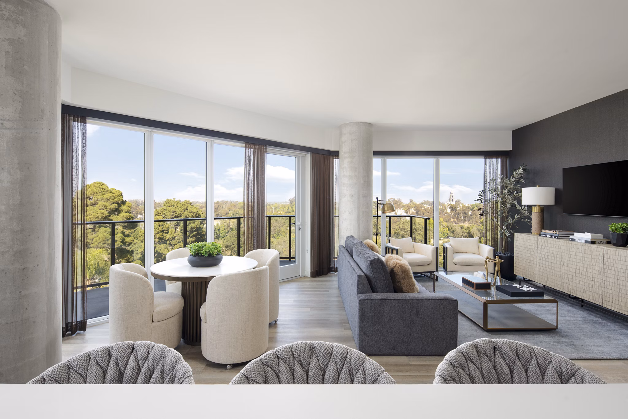 Modern kitchen with stainless steel appliances and quartz countertops in 525 Olive Apartments