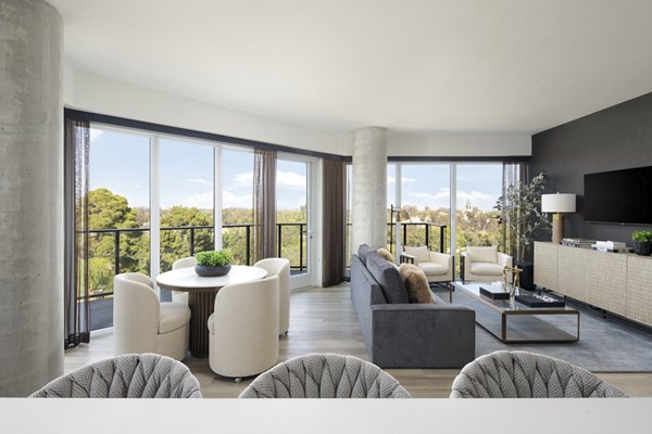 Modern kitchen with stainless steel appliances and quartz countertops in 525 Olive Apartments