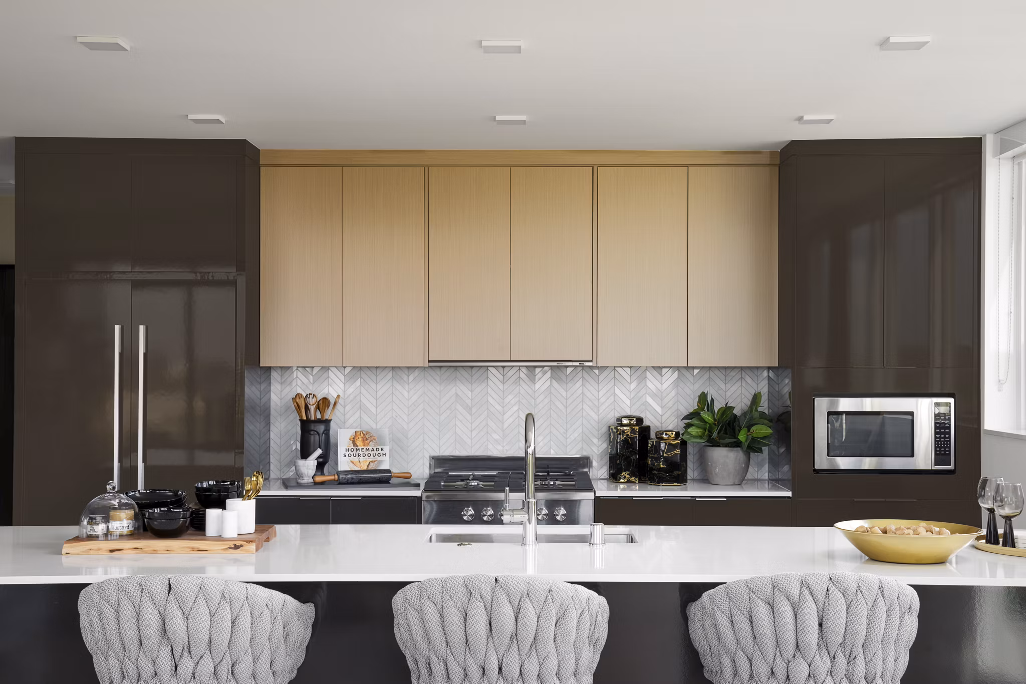 Modern kitchen with stainless steel appliances at 525 Olive Apartments, a Greystar luxury property in an urban setting