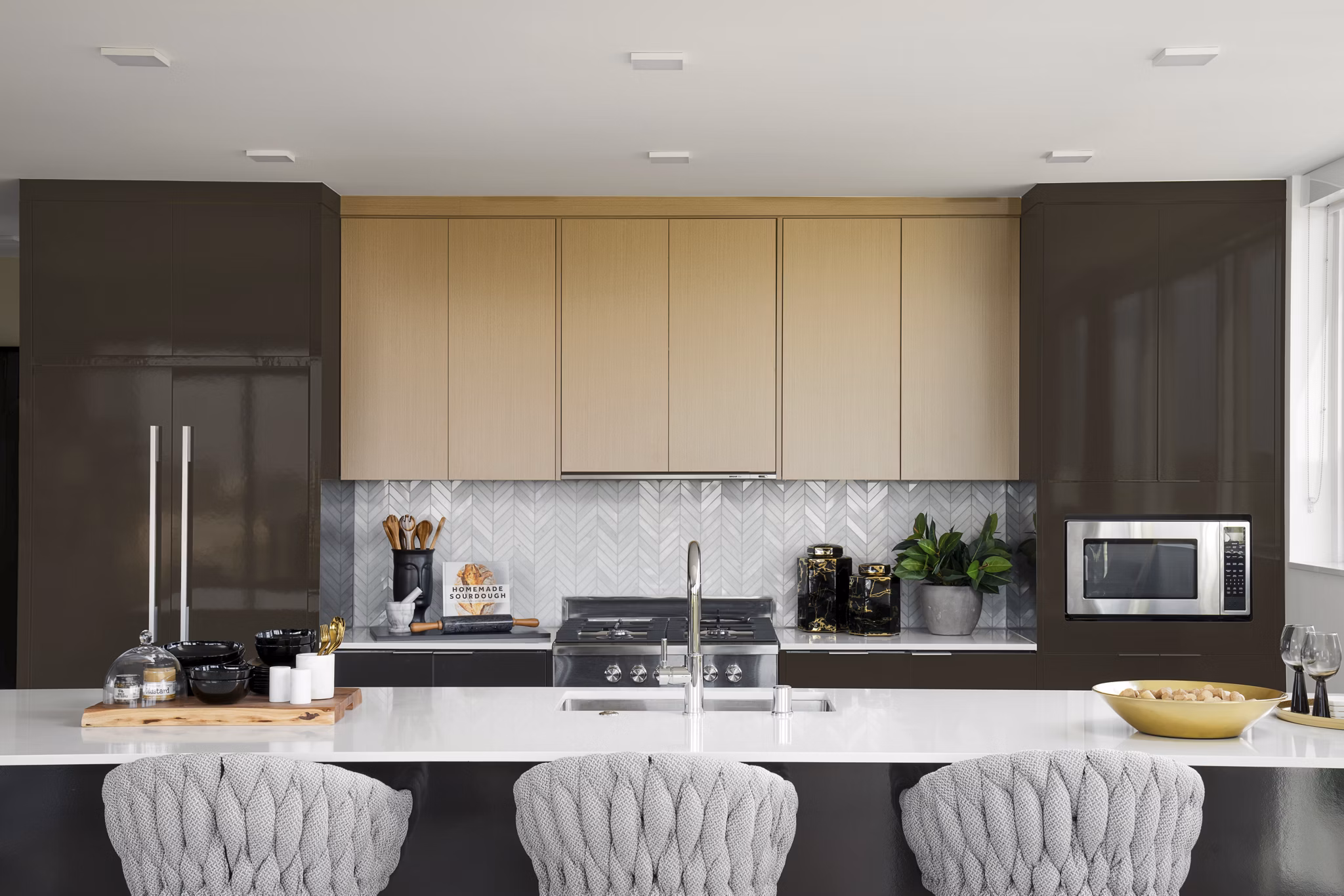 Modern kitchen with stainless steel appliances at 525 Olive Apartments, a Greystar luxury property in an urban setting
