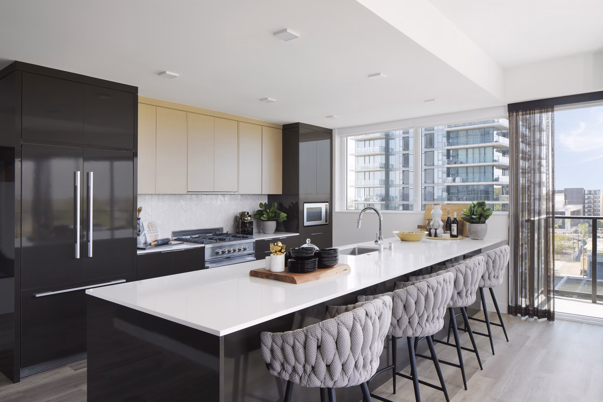 Modern kitchen with stainless steel appliances at 525 Olive Apartments