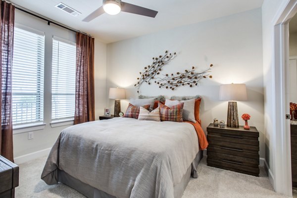 Spacious bedroom with elegant furnishings at Quest Apartments
