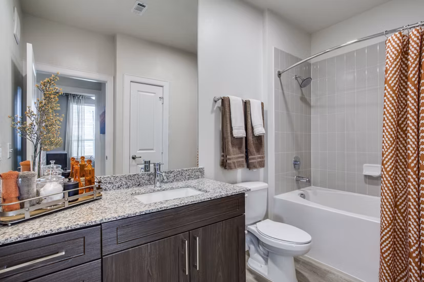 Modern bathroom with sleek fixtures at Quest Apartments, showcasing luxury living at Greystar's premier location