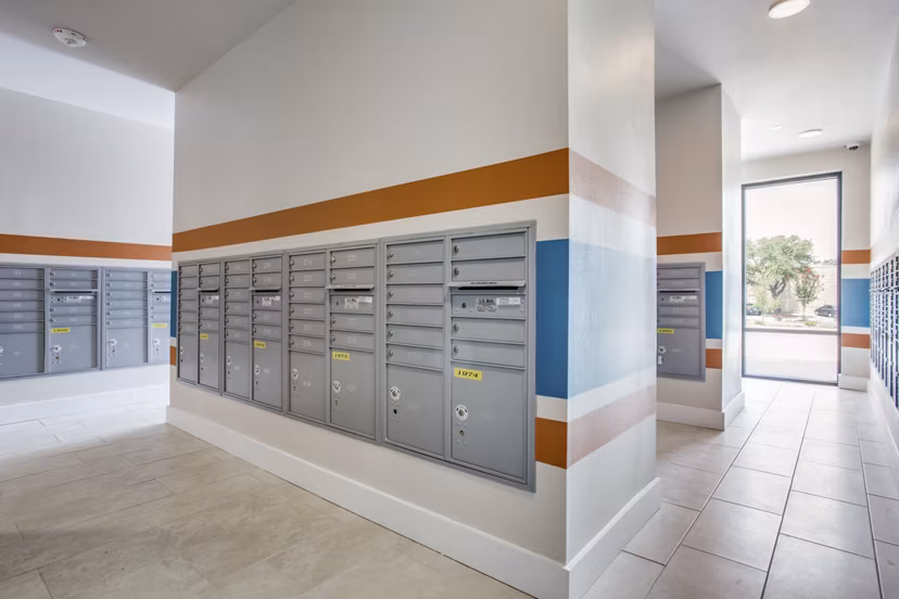 Mail room at Quest Apartments featuring organized parcel lockers for resident convenience