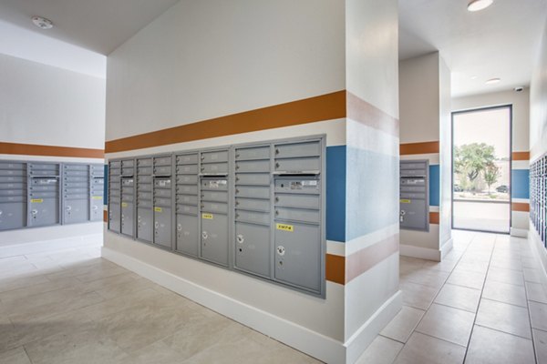Mail room at Quest Apartments featuring organized parcel lockers for resident convenience