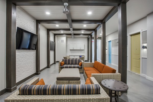 Clubhouse featuring modern design and cozy seating at Quest Apartments