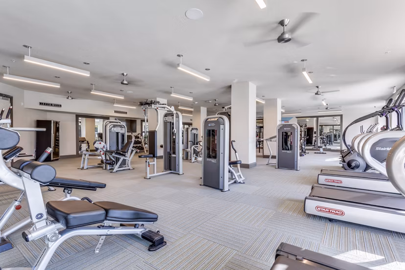 State-of-the-art fitness center at Quest Apartments with modern exercise equipment and spacious workout areas