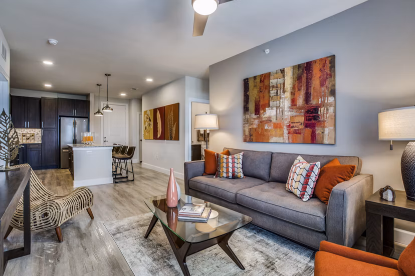 Spacious living room with modern furnishings at Quest Apartments